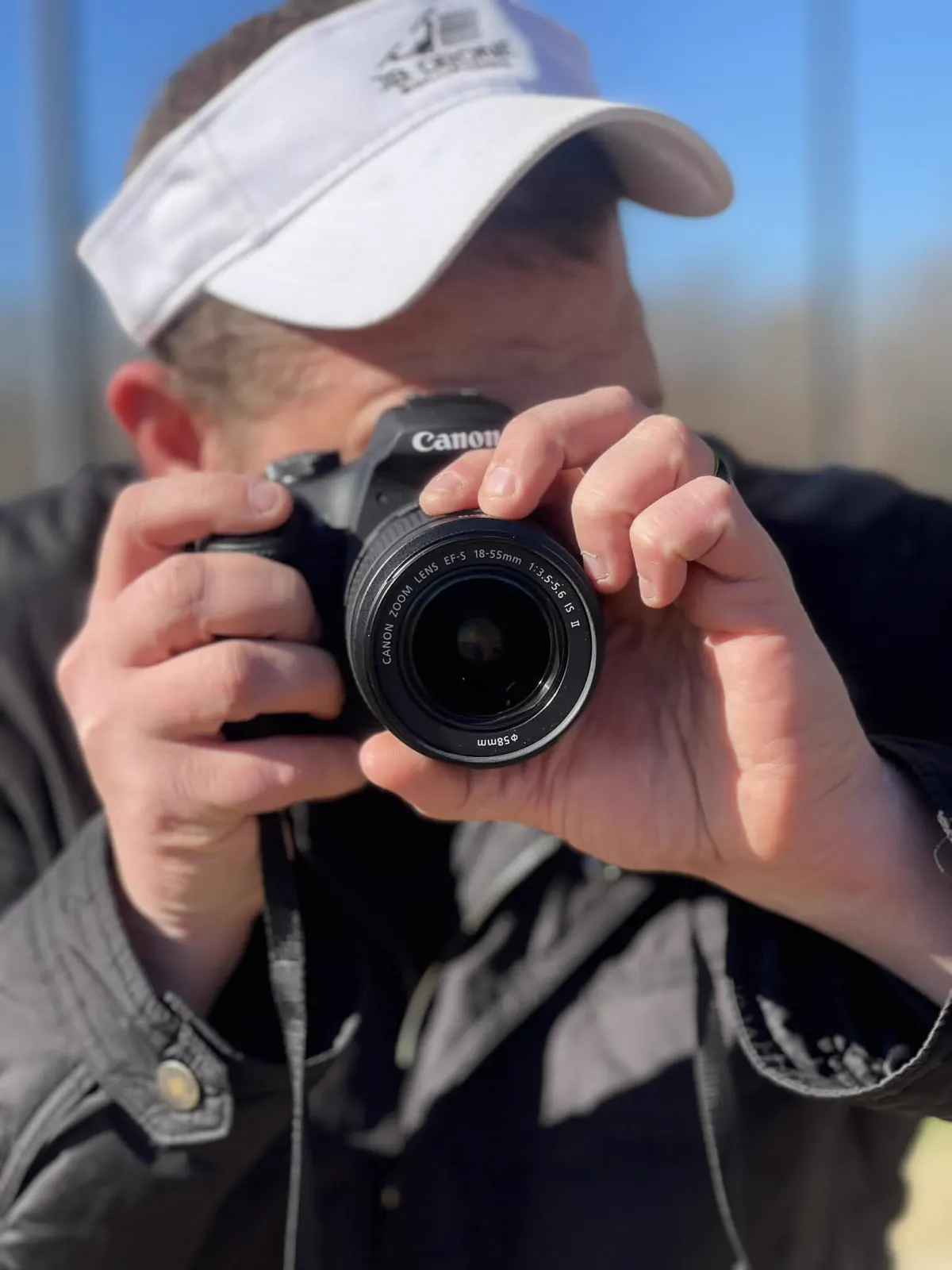 Professional photographer holding a Canon camera on location
